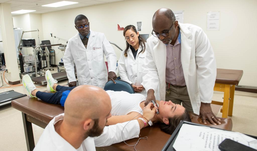 Springfield College PhD in Exercise Physiology students working with a patient