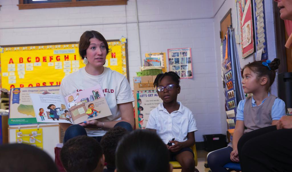 Education student reading to classroom