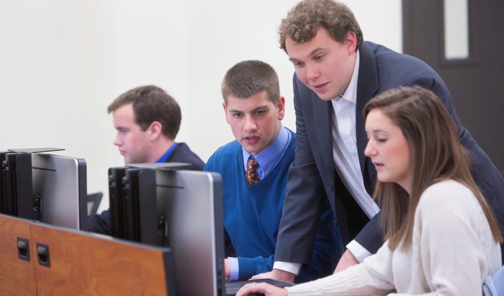 Business students looking at a computer in the classroom
