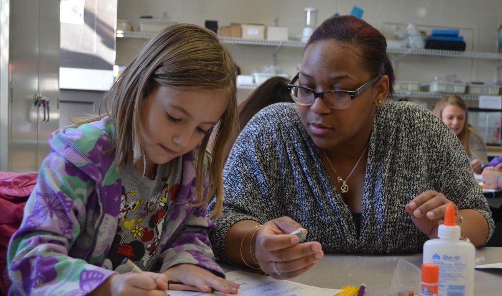 An education student working with a child in an on-campus program.