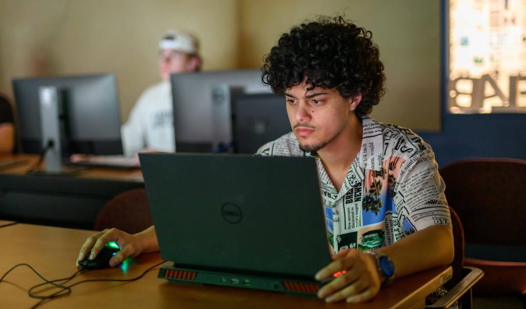 Undergraduate students collaborate during a computer graphic design course in Blake Hall at Springfield College