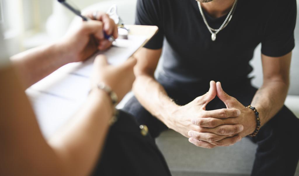 A Man with psychologist theraphy social problems concept drug addiction talk to a psychological woman