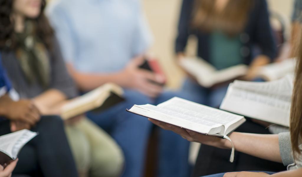 Diverse group of teens studying the Bible.