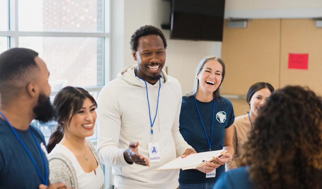 Diverse group of adults enjoys volunteering together stock photo