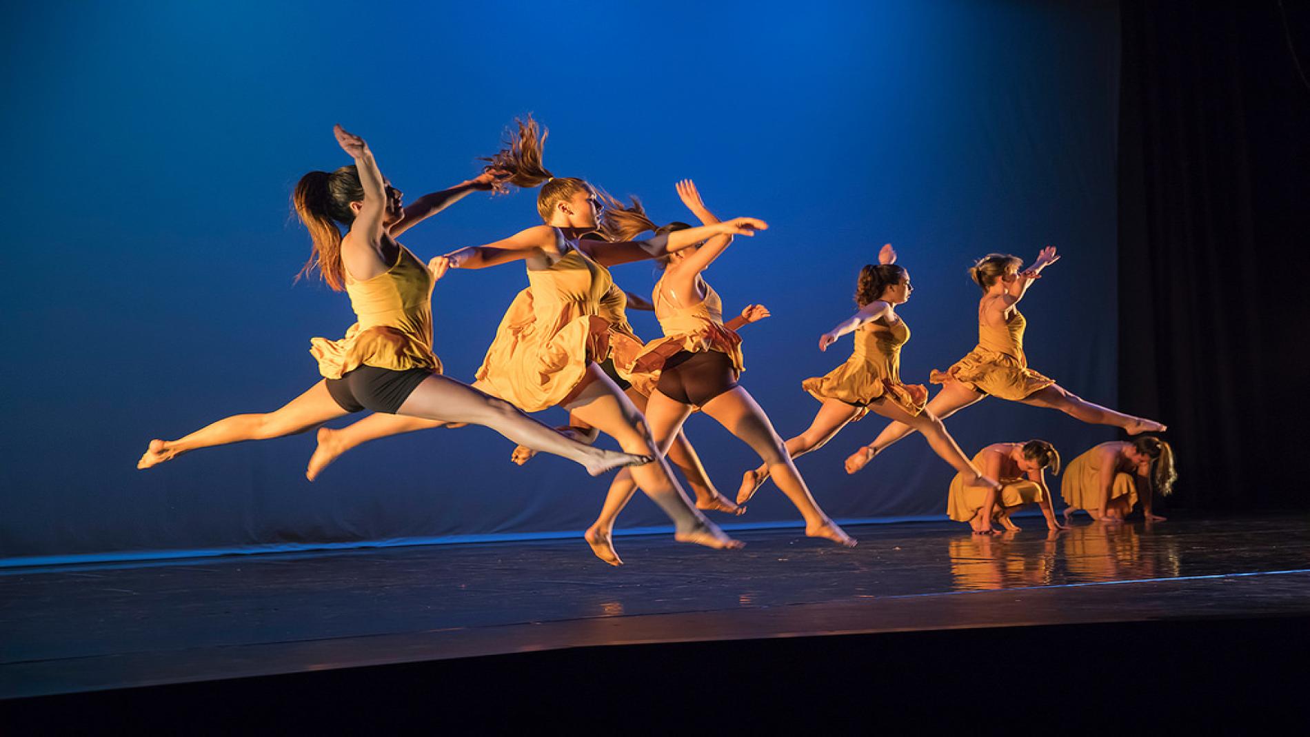 Dancers leap across the stage