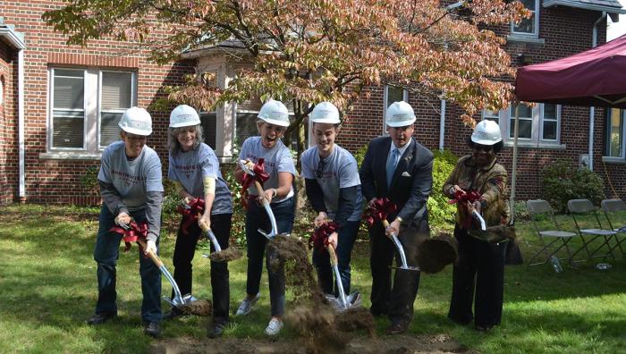 President Mary-Beth Cooper leads a groundbreaking ceremony for the new community center