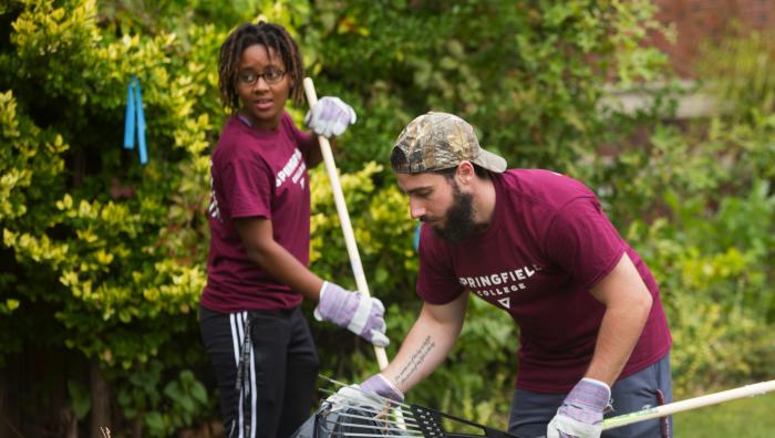 Two students raking leaves during Humanics in Action Day 2016