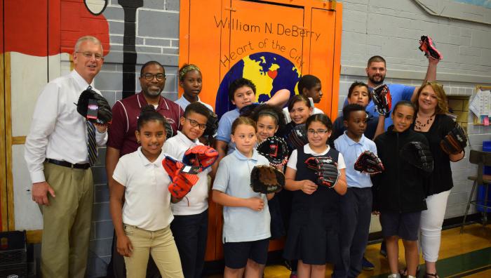 Office of Inclusion delivers baseball gloves to children in the community. 