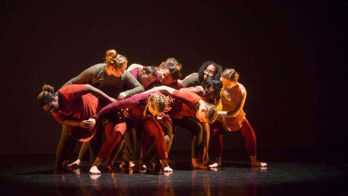 Springfield College Dancers perform a piece where they fall into each other in a clump