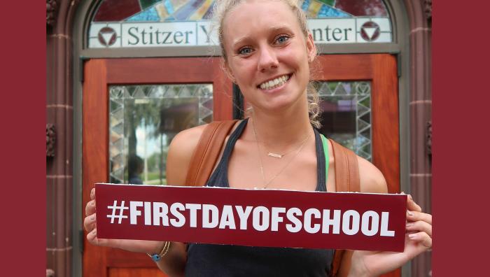 YMCA student posing with sign that says #FirstDayOfSchool